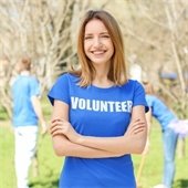 Girl wearing blue shirt that says Volunteer