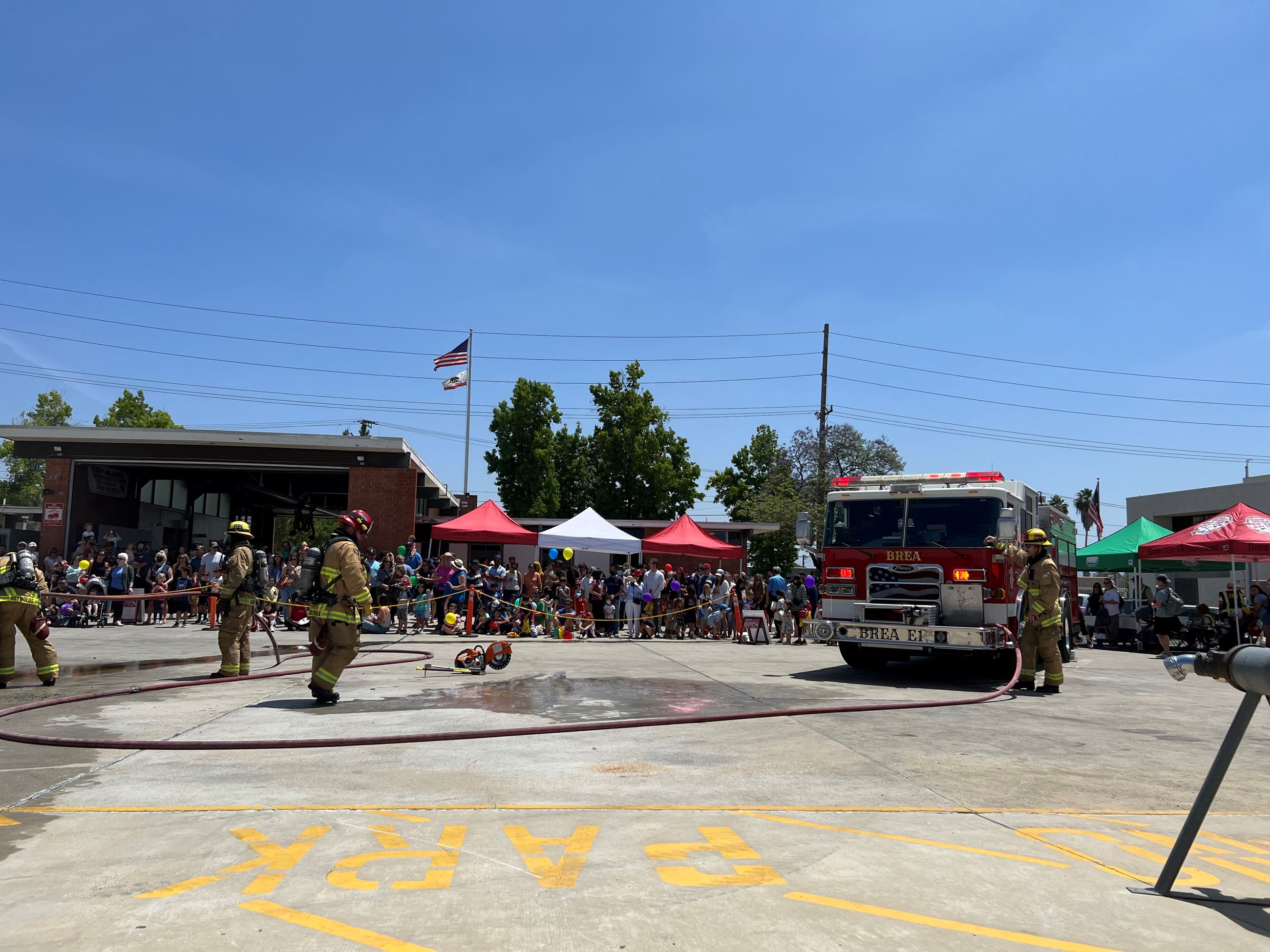Firefighters demonstration to a crowd